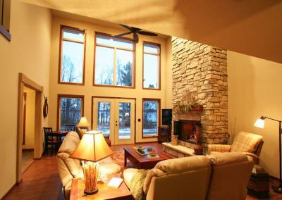 Living room of house with large windows and chimney